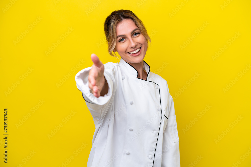 Sticker Uruguayan chef woman isolated on yellow background shaking hands for closing a good deal