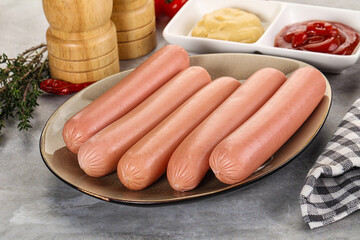 Boiled sausages with ketchup and mustard