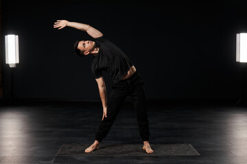 With a mesmerizing blend of strength and suppleness, the young man in black attire exudes a...