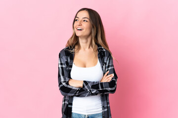 Young Romanian woman isolated on pink background happy and smiling