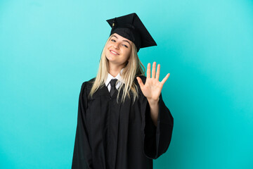 Young university graduate over isolated blue background counting five with fingers