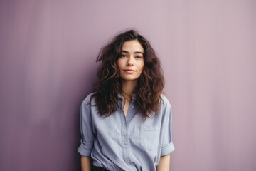 Fototapeta premium In the background image, a female model stands gracefully against a vibrant purple backdrop, exuding confidence and poise amidst the rich hue, setting a striking visual contrast.