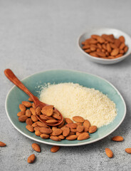 Fresh almond flour in a  bowl and almonds