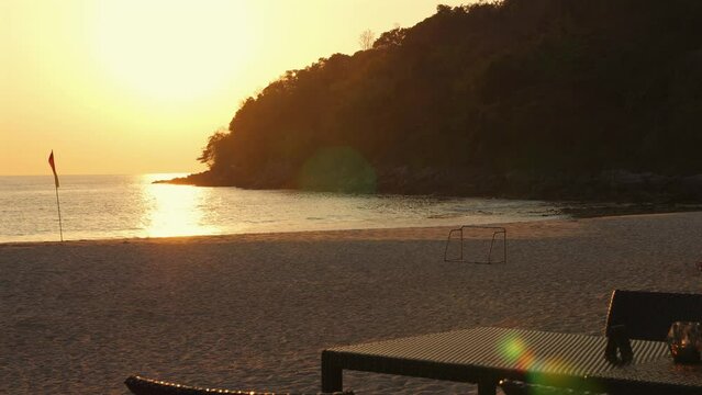 Serene beach scene at sunset with empty chairs and tranquil ocean view. Relaxation and travel destination.