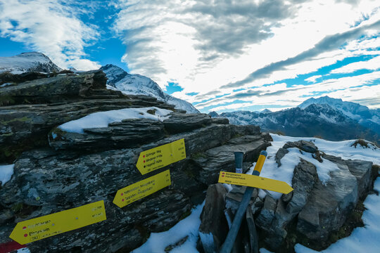 Information signs near alpine cottage Hannoverhaus in High Tauern National Park, Carinthia, Austria. Idyllic snow covered hiking trail with panoramic view of mountain peaks Hochalmspitze and ANkogel