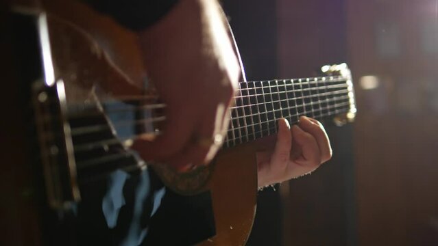 acoustic guitar and hands of musician close-up