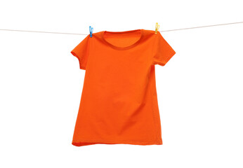 One orange t-shirt drying on washing line isolated on white