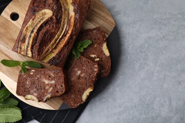 Delicious banana bread on grey table, top view