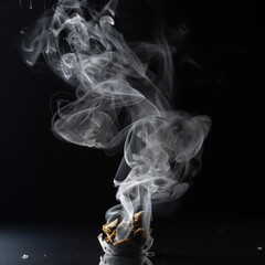 Cigarette stubbing out on black table