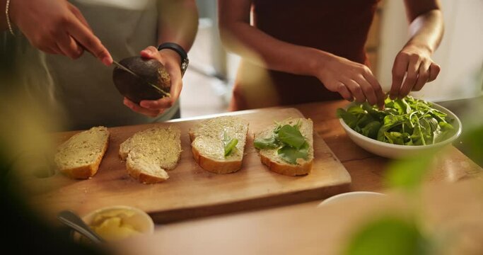 Hands, avocado and bread in kitchen for sandwich on table for health, diet and wellness for breakfast in home. People, toast and prepare lettuce for nutrition, vegan meal and knife for food in house