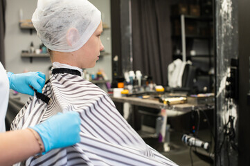 Young Boy Preparing for Haircut in Salon