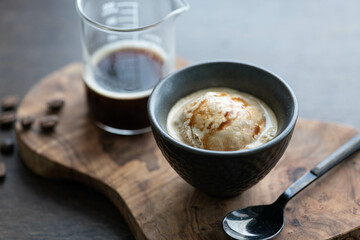 Italian affogato in a ceramic cup on a dark background. Ice cream and coffee, selective focus