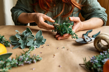Herbal medicine. Woman's hands preparing eco friendly medicinal herbs for drying. Herbalist...