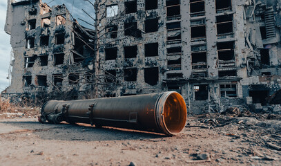 hand grenade launcher against the background of a destroyed house in Ukraine