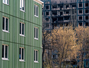 newly built house against the background of the destroyed and burned during the fighting in Ukraine