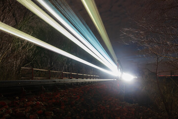 Train ride on railway at night. Transportation concept, light trails, long exposure