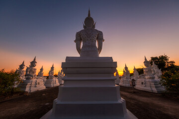 Buddha statues lined up in the temple in the morning