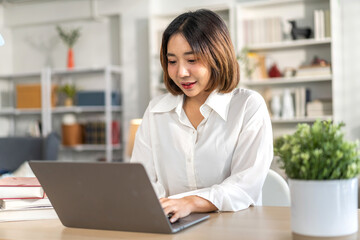 Young smiling asian woman happy relax use laptop conference work,learning, education, shopping, study online, webinar, online marketing, business, blog, digital internet advertising at home