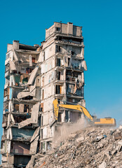 construction equipment destroys houses damaged during the war in Ukraine