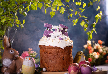 Easter Cake with dried fruits and nutson a wooden table. Delicious traditional bakery and painted...