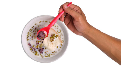 Hand holding a spoon of green bean porridge on an isolated transparent background