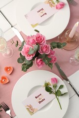 Romantic table setting with flowers and candles, flat lay