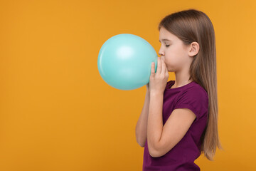 Girl inflating bright balloon on orange background, space for text