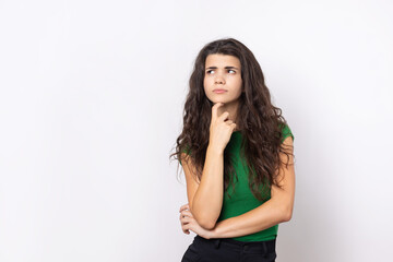 Fototapeta premium Portrait of a beautiful young woman thinking, isolated on white background