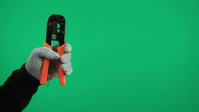 Tool for crimping RJ-45 connectors 8P8C, twisted pair crimper for crimping connectors on a green background.
