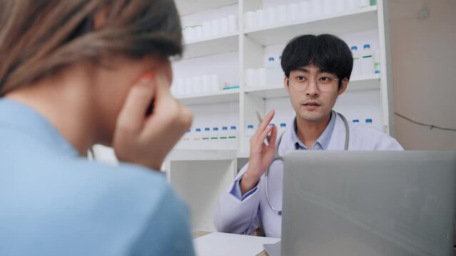 Asian female patient have symptoms toothache to consulting doctor at clinic. Asian customer woman want to buying medicine gum inflammation relief with pharmacist man at pharmacy shop.