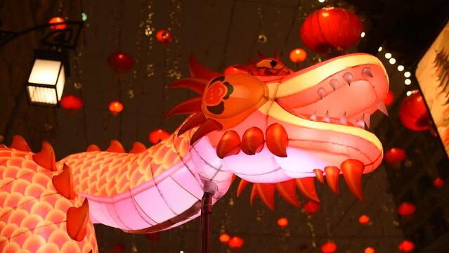 inflatable dragon and red Chinese round lanterns on the night street. Chinese New Year in Moscow.