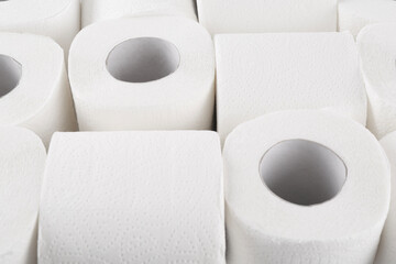 Many soft toilet paper rolls as background, closeup