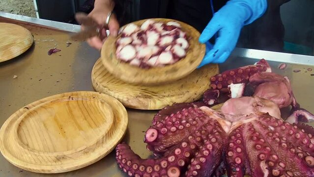 Unrecognizable person preparing galician octopus