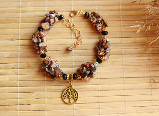 Delicate vintage bracelet made of a mix of natural stones jasper, jade with a golden tree of life...