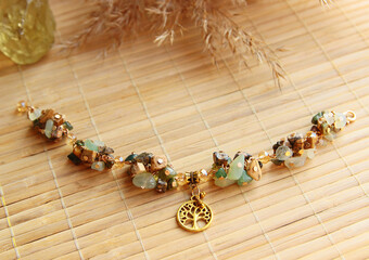 Delicate vintage bracelet made of a mix of natural stones jasper, jade with a golden tree of life...