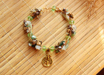 Delicate vintage bracelet made of a mix of natural stones jasper, jade with a golden tree of life...