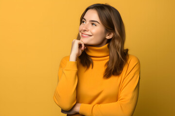 Cheerful girl in casual attire, deep in thought, against vibrant background.