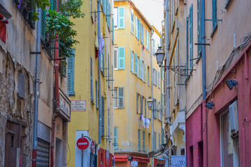 Fototapeta na wymiar Nice, France, 02/13/2024: The architecture of the old town in Nice boasts a blend of Italian style with French motifs, characterized by colorful houses and narrow streets.