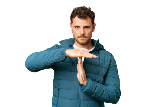 Brazilian man over isolated chroma key background making time out gesture