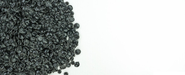 Macro shot of a raw plastic pellets on the left with copy space on the right. Industrial materials...
