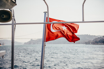 Turkish national flag on board of a boat sailing along Bosphorus in Istanbul, Turkey.