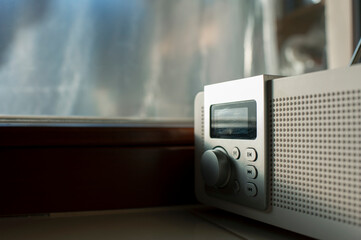 Alarm clock radio with the early hour on the windowsill display