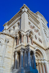 Small part of the facade of the Cathedral of St. Nicholas in Monaco against the blue sky