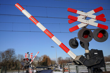 Railway crossing with red lights and barrier in the Zuidplaspolder