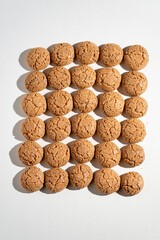 Sweet almond biscuit on the white background, apettize biscuit, pepper nuts, sweet dessert aranged on the background, biscuit arranged in lines
