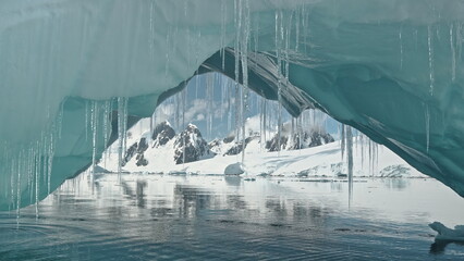 Glacier arch at ocean bay seascape aerial. Environment issue of melting iceberg and global warming....