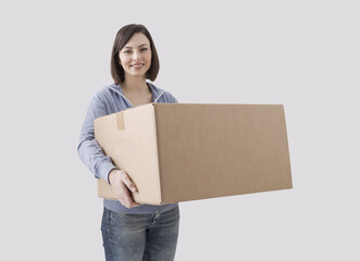 Happy woman holding a cardboard box