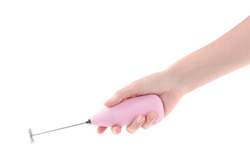 Woman holding pink milk frother wand on white background, closeup