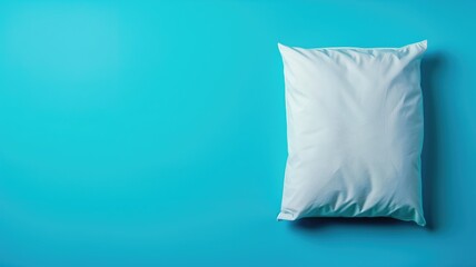 Fototapeta na wymiar Pillow on a solid blue background