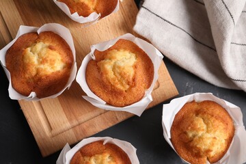 Tasty muffins on grey table, flat lay. Fresh pastry
